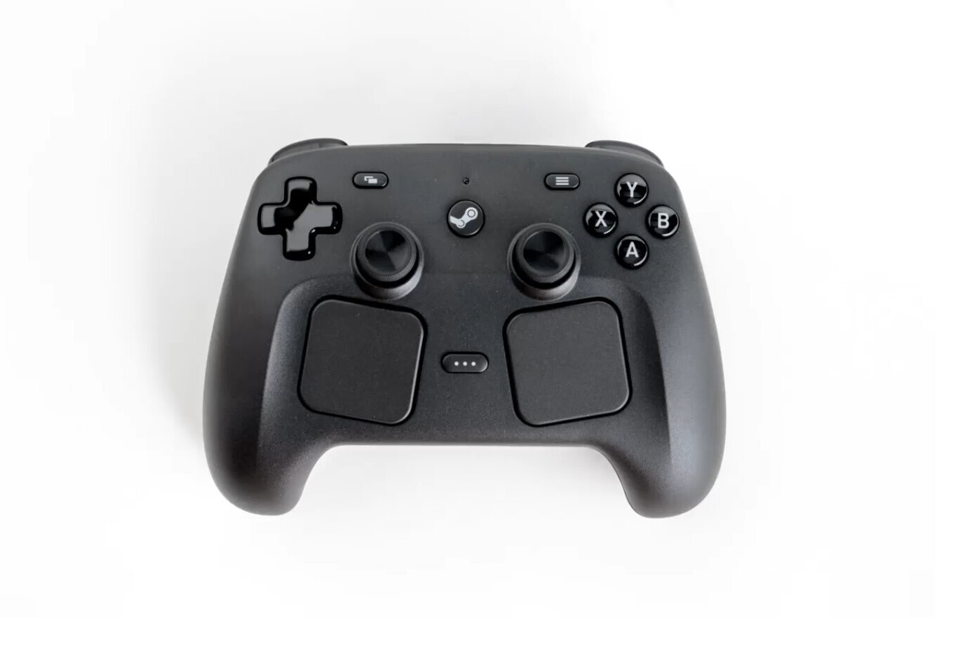 Overhead product photo of the 2026 Steam Controller: black body with D-pad, dual thumbsticks, ABXY cluster, Steam button, and two large square trackpads below the sticks.